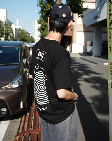 ANACHRONORM ヴォルテックス プリント 半袖Tシャツ ブラック | 90年代 音楽カルチャー グラフィック 渦 コットン100%